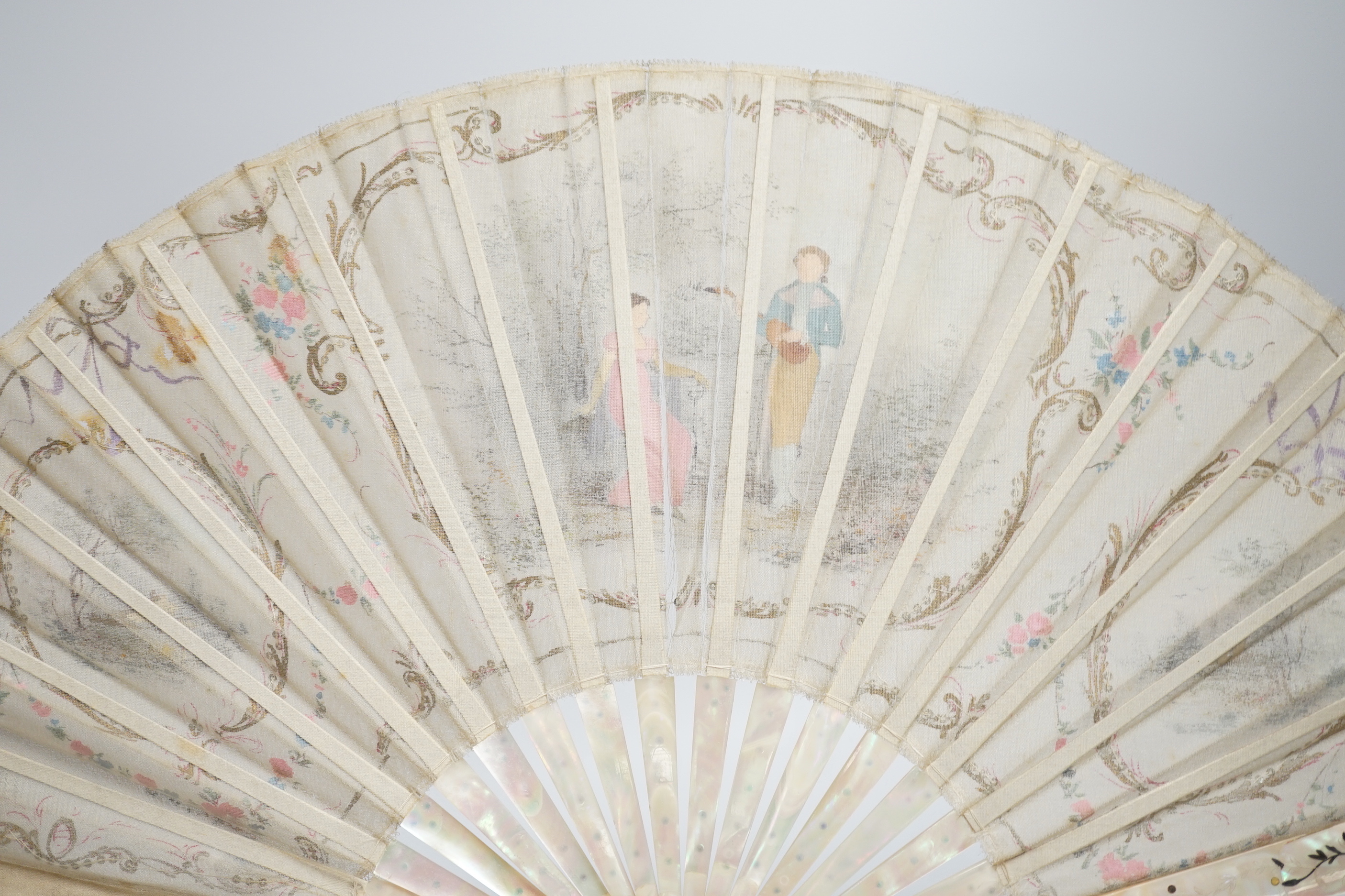 An Edwardian mother of pearl and fine gauze hand painted fan in satin and sequin case